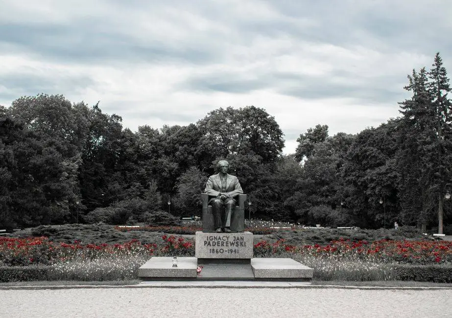Monument of Ignacy Jan Paderewski surrounded by trees in Warsaw park, Poland.