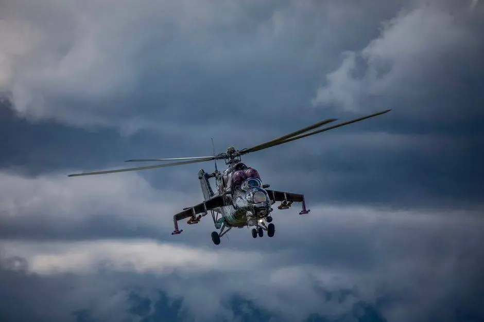 A Mi-24 military helicopter flying through overcast skies in Slovakia.