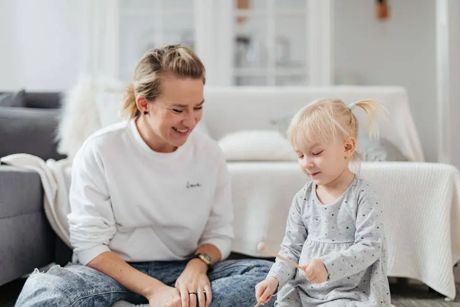 A joyful mother and daughter duo playing xylophone together in a cozy living room.