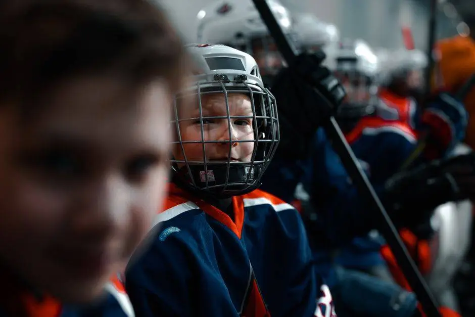 Young hockey players on the bench ready for action during a game.